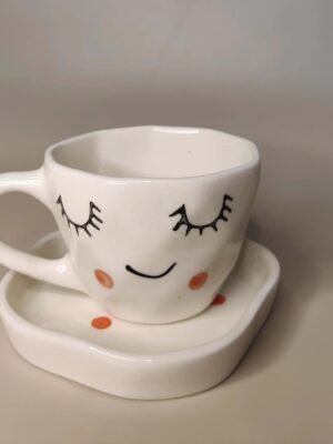 Decoroid Handcrafted White Ceramic Cup Handcrafted White Ceramic Cup & Saucer Set – Cute Sleepy Face Print Tea Cup for Kitchen & Table Décor